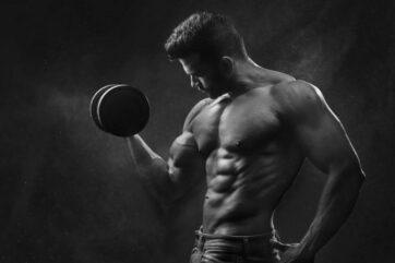 man holding black dumbbell