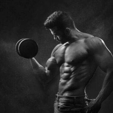 man holding black dumbbell